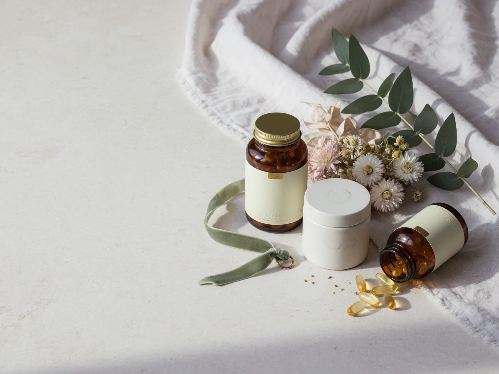 Curated wellness products arranged on a cream stone surface